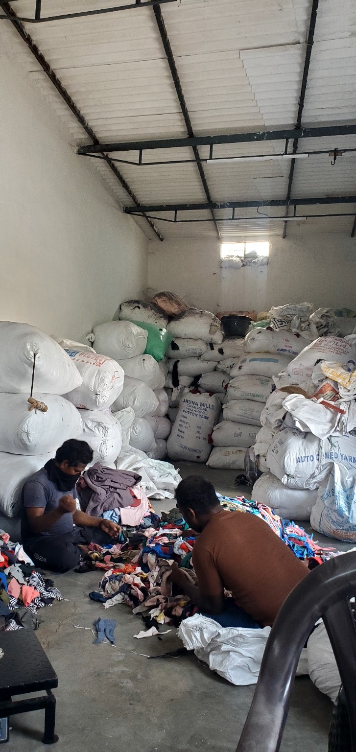 Cotton waste being sorted inside a warehouse