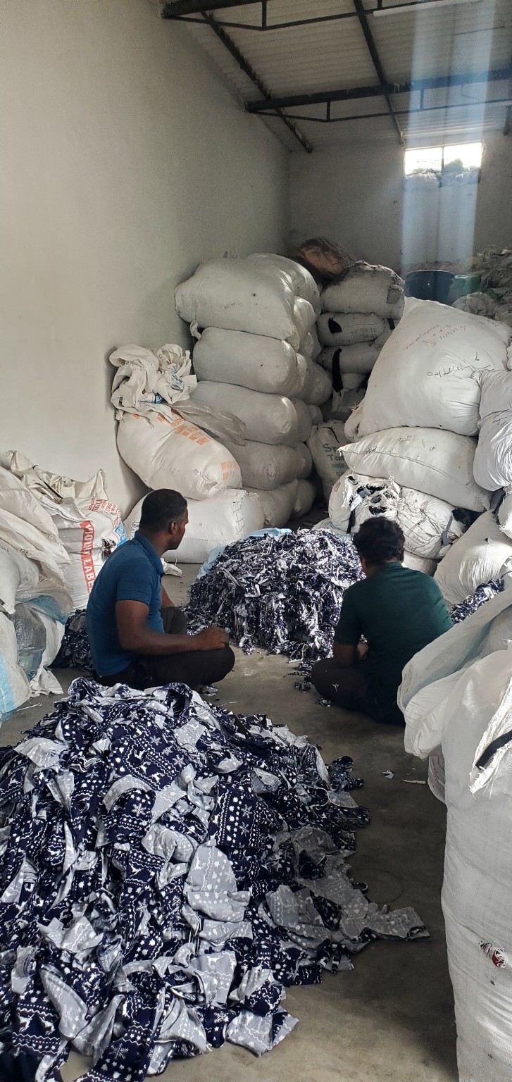 Bulk cotton waste stock stored in bags